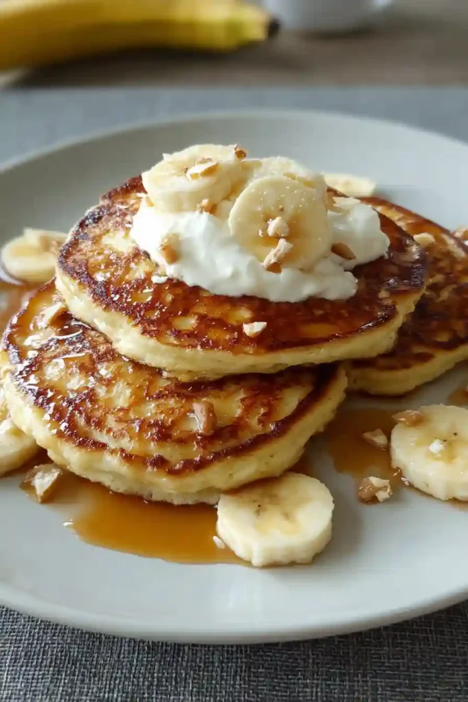 Perfectly cooked banana cottage cheese pancakes with golden brown surface on non-stick pan