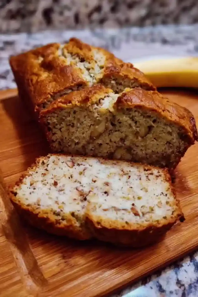 Freshly baked cottage cheese banana bread cooling on wire rack after removing from loaf pan