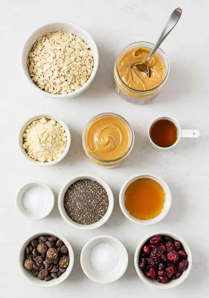 Measured ingredients including oats, peanut butter, protein powder, and honey laid out on a counter