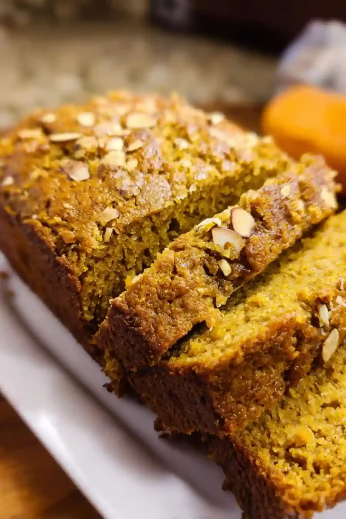 Golden brown almond flour pumpkin bread cooling on wire rack after baking