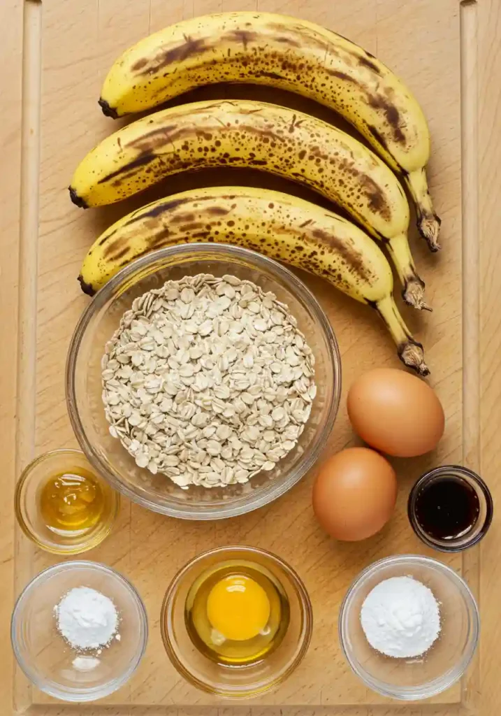 Banana oatmeal bars ingredients including ripe bananas, rolled oats, honey, eggs, and vanilla