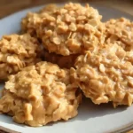 Peanut butter no bake cookies with oats on wooden board with glass of milk
